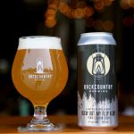 Backcountry Brewing | Blew Out My Flip Flop Pina Colada Sour - Can & Glass on a table